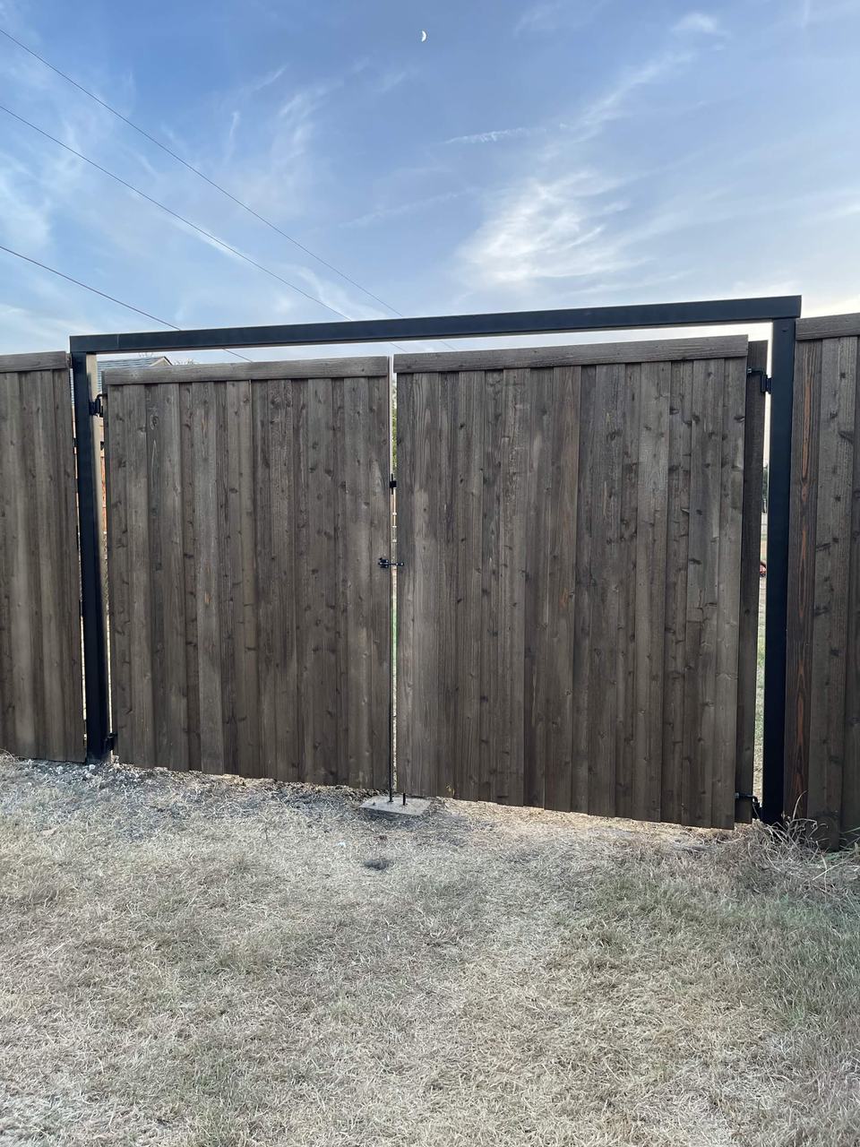 Cedar driveway gate with steel header frame
