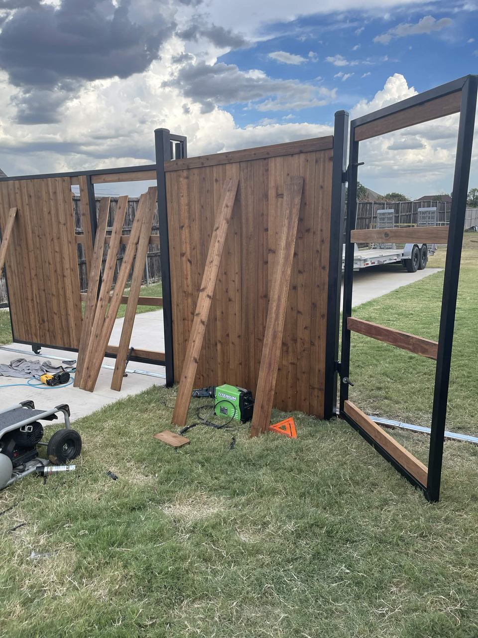 Cedar gates on steel frames going up