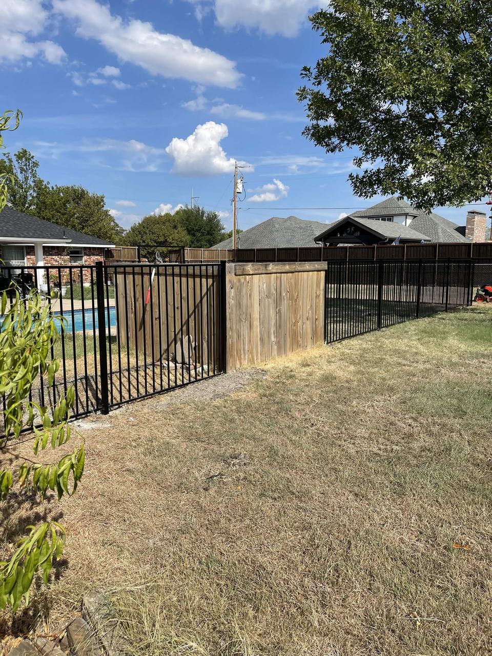 Iron pool fence with cedar privacy section