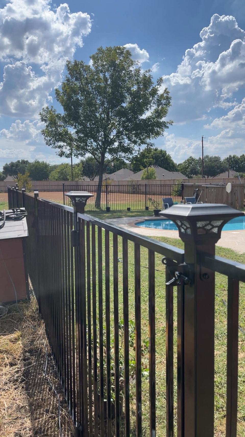 Iron pool fence with solar post cap lights