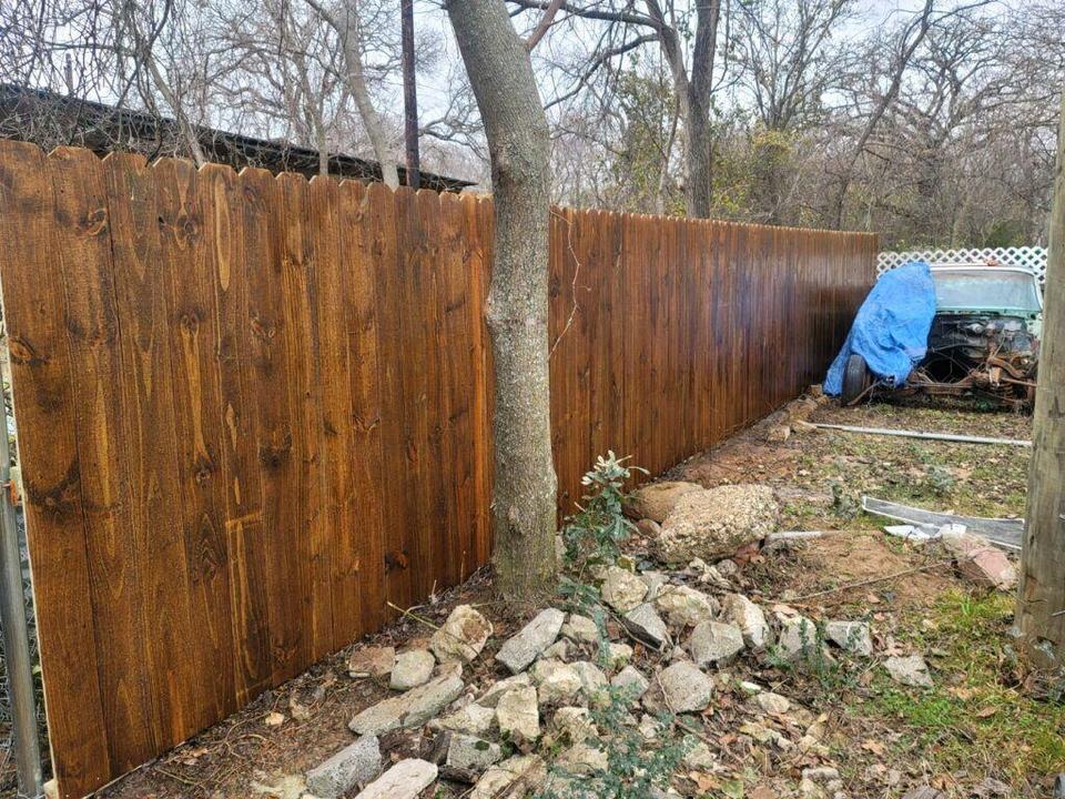 Freshly stained side-by-side wood fence